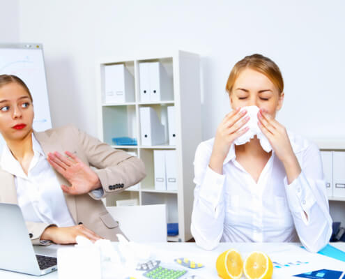 Young woman feeling unwell and sick in office