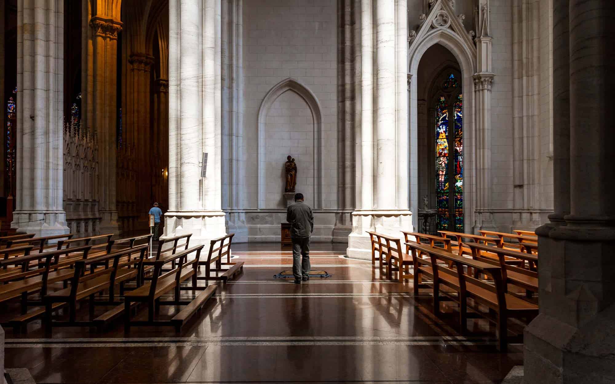 A worker mops the floor of a church