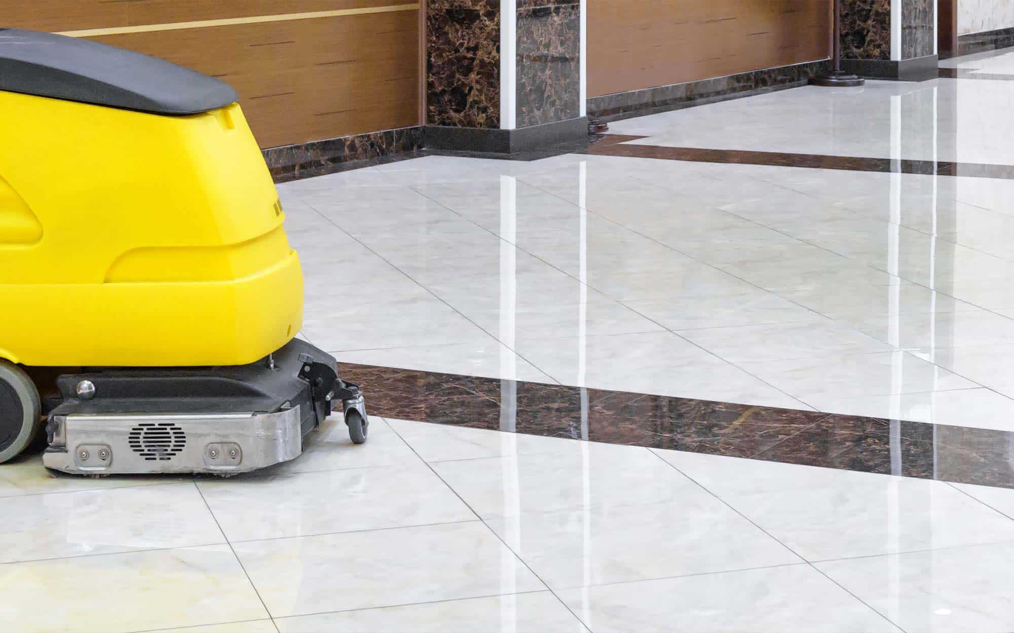 Cleaning machine on marble floor in office